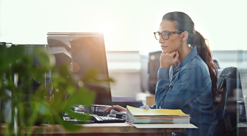 Female worker intently working at her desk