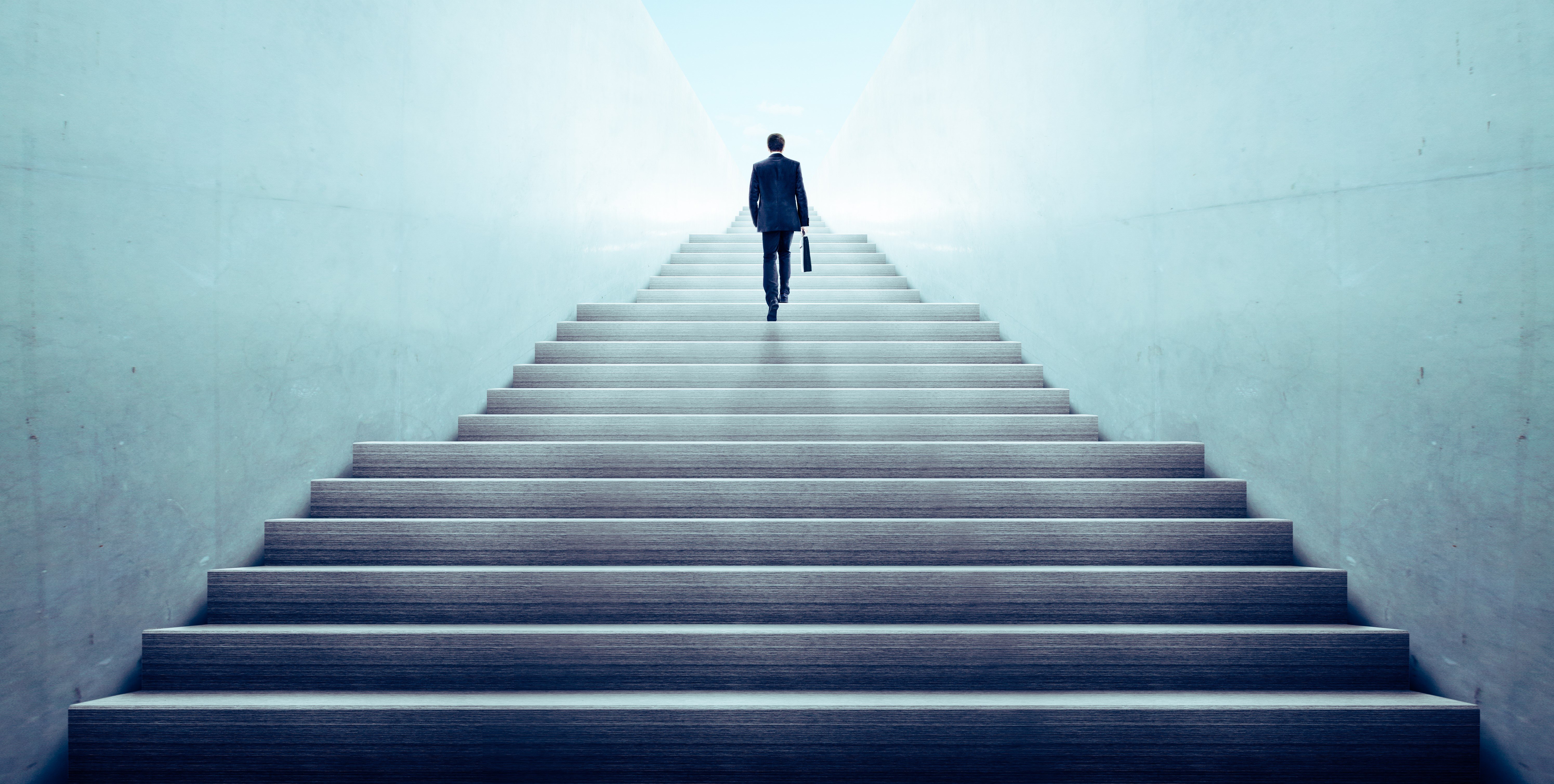 silhouette of a leader ascending stairway to exit